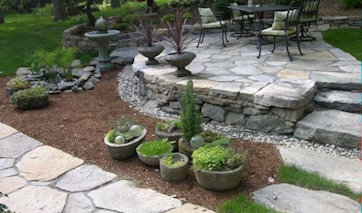 Custom native Connecticut fieldstone walks, patios, walls and stairs are our specialty, many times accompanied by bluestone features. We lay several million pounds of stone each year and this portfolio highlights some of our projects.